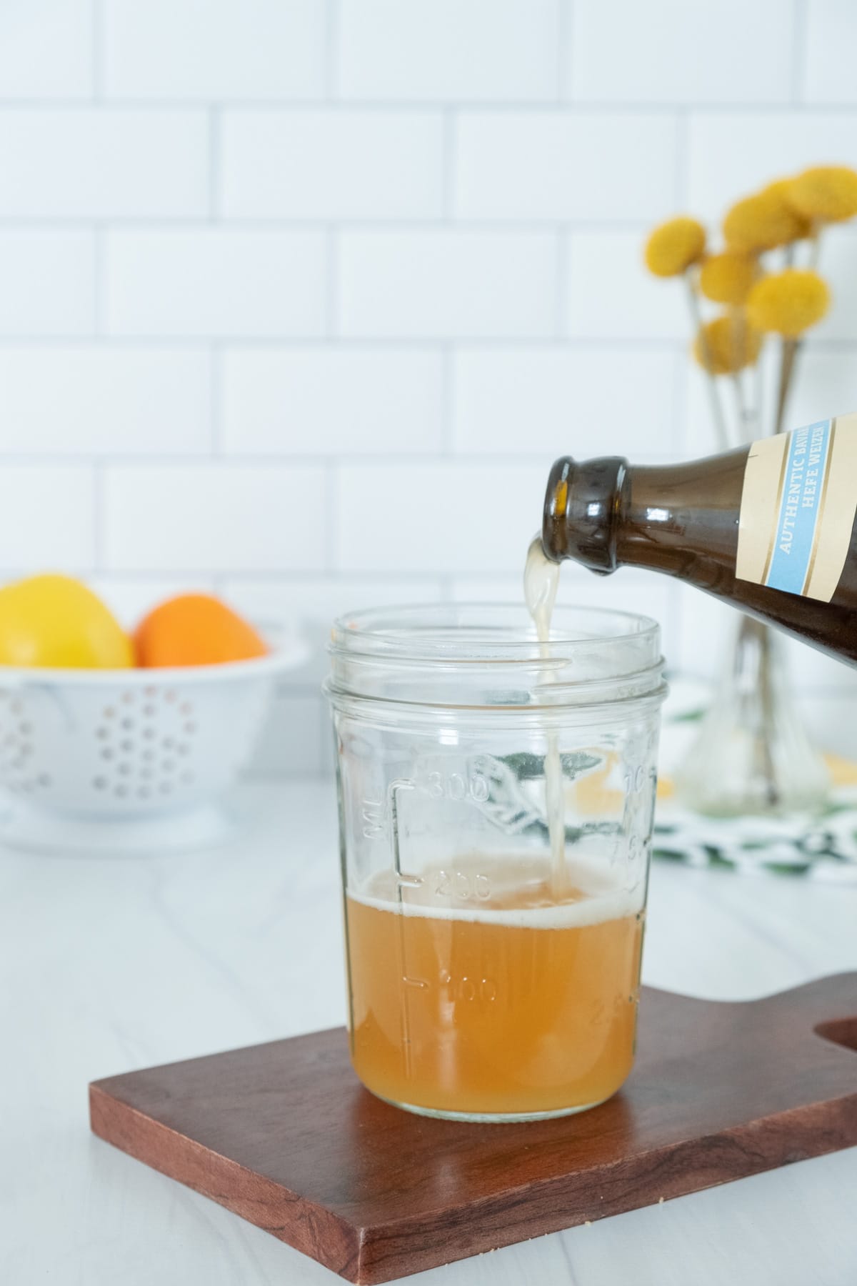 pour beer into a glass
